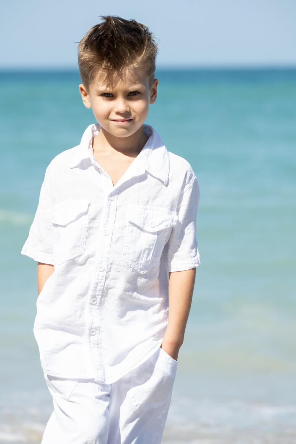 Boy on beach in white shirt