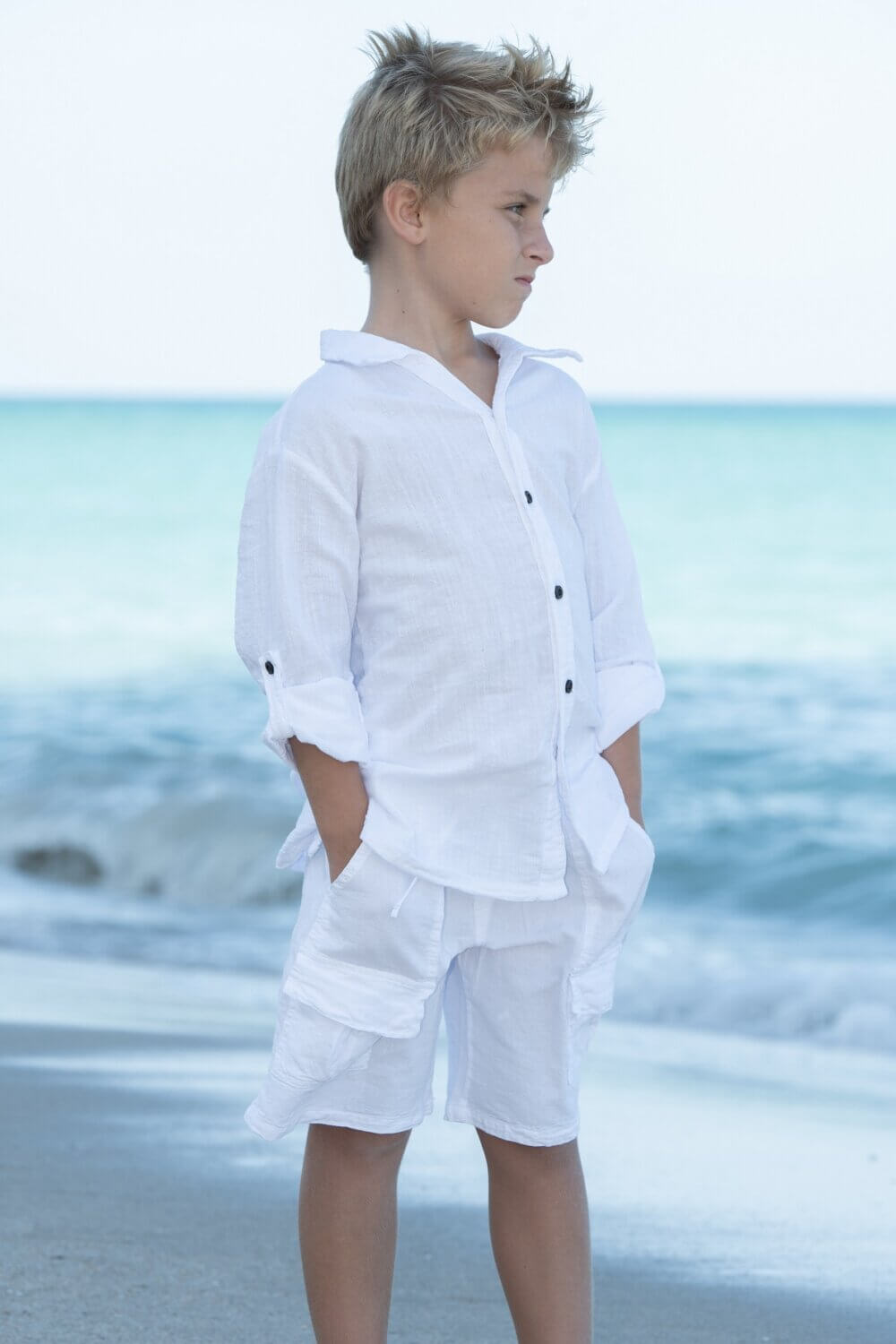 Boy on beach with white outfit