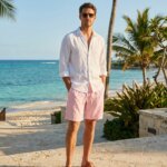 Man in white shirt and pink shorts